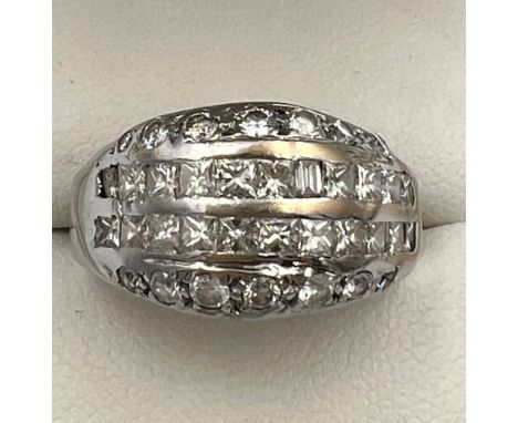 An 18 carat white gold ring set with brilliant and princess cut diamonds. Size R/S. Weight 5.1gm. 