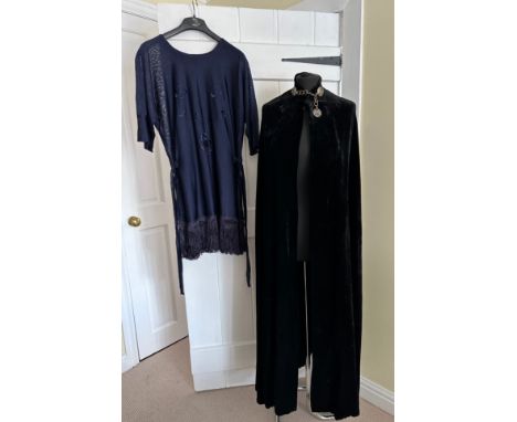 A black velvet evening cape with metal fastening detail together with a vintage fringed tabard top with ties. Cape length 130