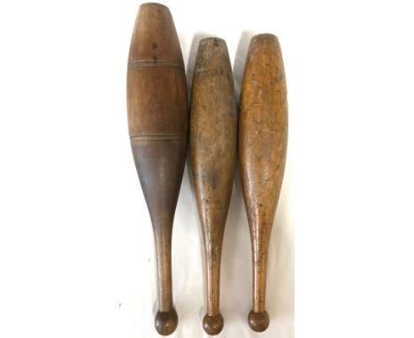 A miscellany of three wooden juggling pins largest 56cm h along with three brass candlesticks, single one 15cm h, base approx