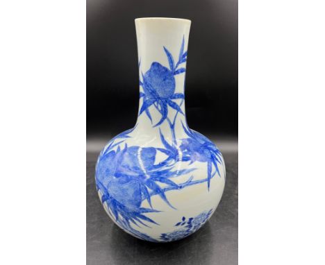 A Chinese blue and white nine peaches bottle vase marked Qianlong. 40cm h. Hole drilled for lamp.Good condition, nothing to r