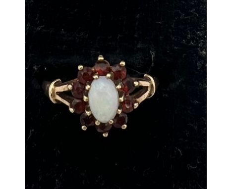 A garnet and opal cluster ring set in 9 carat gold. Size K. Weight 1.6gm. 