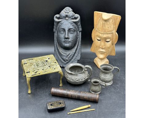 Miscellany to include two masks, one wood, one cast iron approx 30cm h, a brass trivet, three pewter items, a jug and two mea