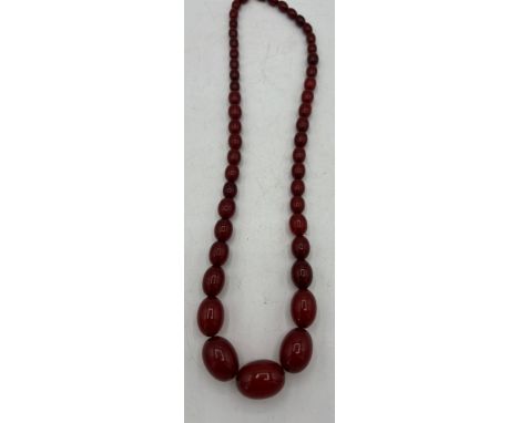 A string of vintage cherry amber coloured beads. 66cm l. 57gm.
