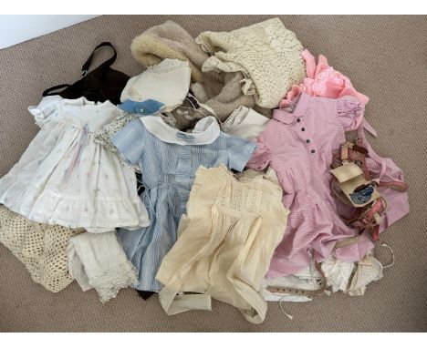 A large quantity of children's and doll's clothes to include 19thC cotton tabards, one marked Eliza Nicholson 1878, christeni