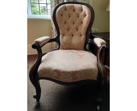 A 19thC rosewood open armchair, button backed with cabriole legs.