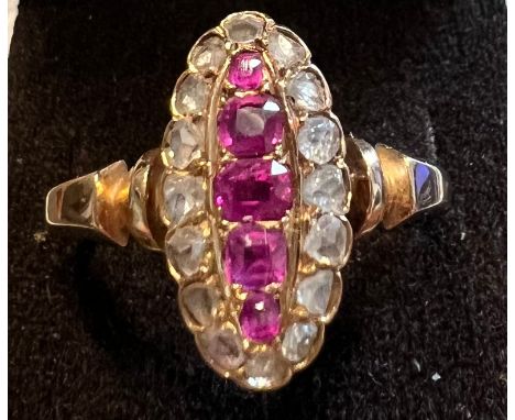 A late 19thC/early 20thC rose cut diamond and ruby ring on unmarked rose coloured metal. Size S/T. Weight 4.6gm.