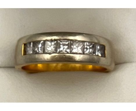 An 18 carat yellow gold ring set with princess cut diamonds. Size R/S. Weight 9.3gm. 