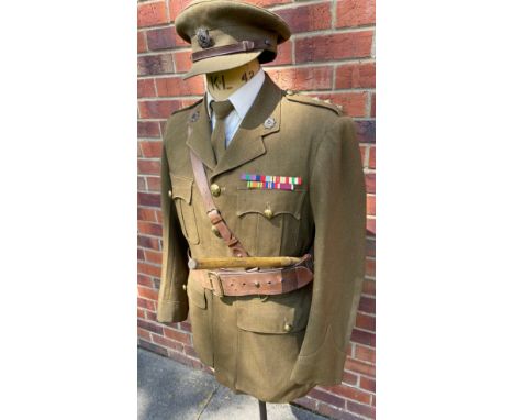 A WW II 1st Army Officers Service Dress uniform consisting of Cap, Tunic, Sam Brown belt, swagger stick, trousers and later s