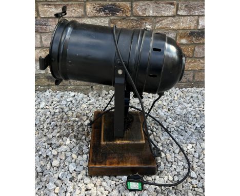 A black vintage theatre lamp mounted on a wooden base. Approx 55cm h. 