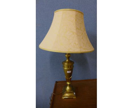 A brass urn shaped table lamp