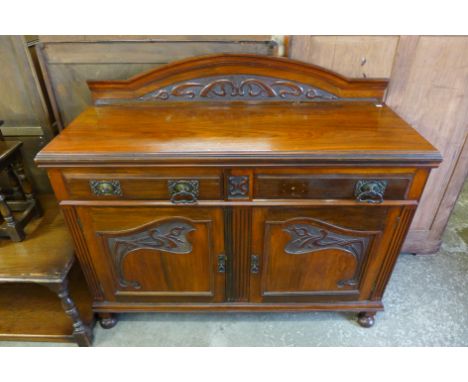 An Art Nouveau walnut sideboard