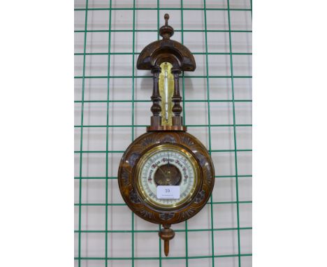 A Victorian carved walnut aneroid barometer and thermometer