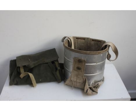 A vintage apple harvesting bucket with an army canvas knap sack