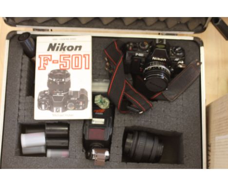A Nikon-501 camera with Nikor 50mm zoom, with a FH 80 flash unit, a Sigma UC zoom 28-70mm, in a flight case, together with an
