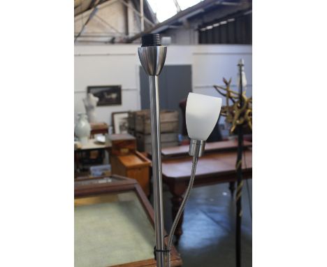 A chrome based standing lamp with second adjustable spot light with a floral lamp shade