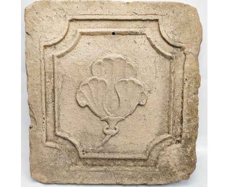 A finely carved 18th century Mughal Indian yellow stone tile depicting a flower, 38cm x 36cm