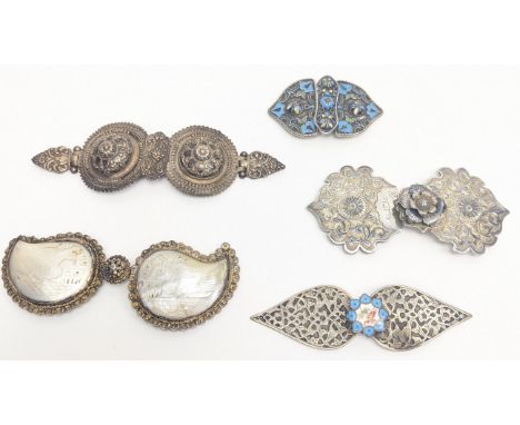 A fine collection of five Ottoman belt buckles to include a niello inlaid silver gilt buckle signed (Ahmad) and dated 1317/18