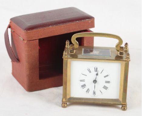A French brass and glass cased carriage clock, in travel case, 4 1/2" high