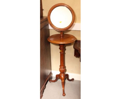 A Victorian mahogany circular shaving stand, fitted mirror, on tripod base