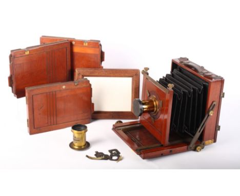 A late 19th Century mahogany plate camera with accessories to include a brass lens by Talco London and Leeds, one other brass