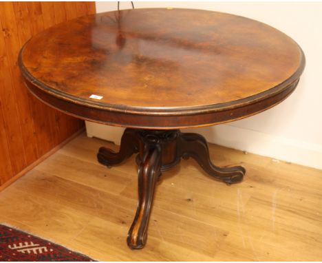 A 19th Century burr walnut tilt-top dining table, on carved tripod base, 53" dia
