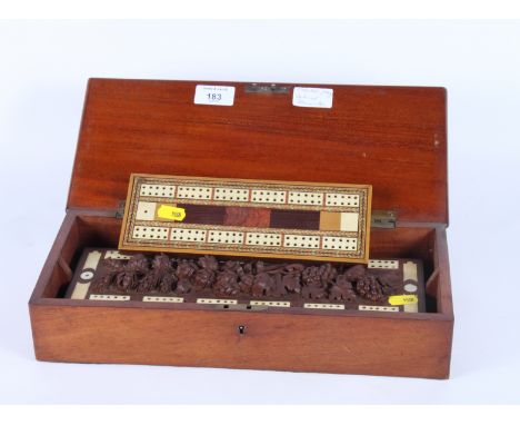 A mahogany and bone cribbage marker board with central panel carved fruit in high relief, in fitted mahogany box, and another