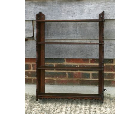 A late 19th Century mahogany three-tier open wall shelf with Gothic piercings, 24" wide
