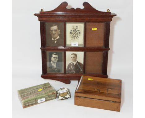 An olive wood cigarette box inlaid birds, a cream and gilt decorated strut clock, a six panel mahogany photograph frame and a