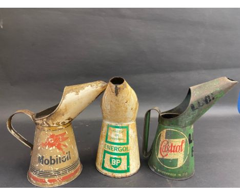 A Mobiloil quart measure, a BP Energol Tractor Oil measure plus a Wakefield Castrol quart measure. 