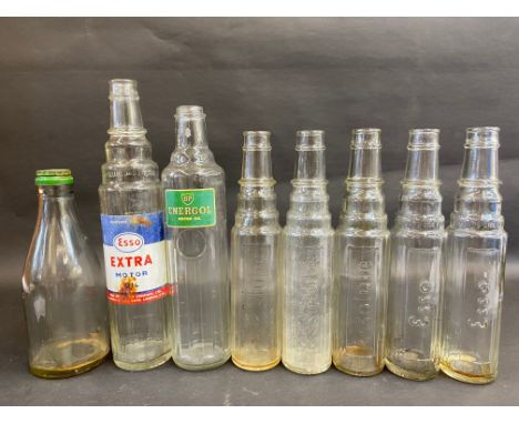 A selection of glass oil bottles including Esso and BP.