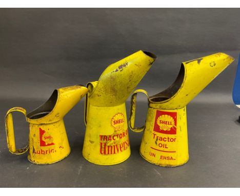 Two Shell Tractor Oil quart measures and a Shell pint measure.