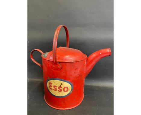 A garage filling station watering can, bearing Esso decals.