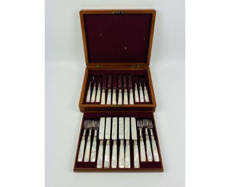 A two tier mahogany cased set of decorative mother and pearl knives and forks. 29cms wide x 24cms deep x 6cms high (mahogany 