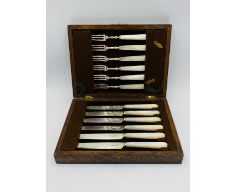 A canteen of silver and mother of pearl cutlery, comprising six knives and six forks, Sheffield 1906, in fitted wooden box. E