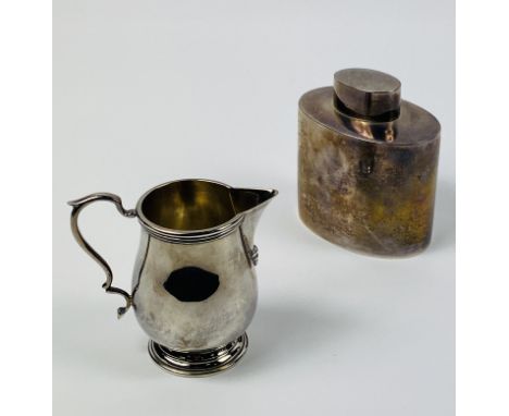 A silver milk jug, 96g; together with a silver tea caddy, 111g. Estimate £100-120.