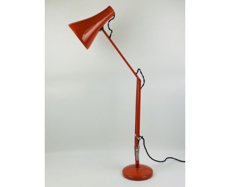 A weighted mid century Herbert Terry red Anglepoise table lamp, set upon a circular base, 88cms high x 15.5cms base diameter.