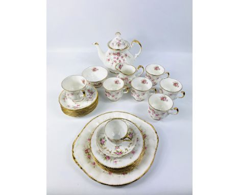 A Royal Albert Victoria Rose part tea service of approximately 23 pieces to include cups, saucers, plates, sugar bowl and mil