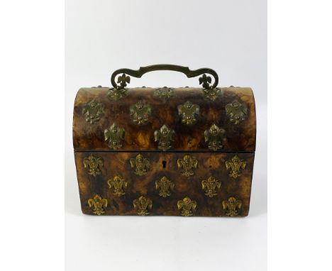 A good Victorian burr walnut dome top tea caddy with applied brass fleur-de-lys decorative mounts throughout, the interior wi