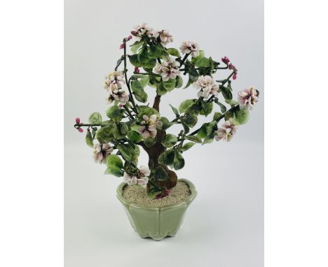 A large Chinese decorative hardstone flowering tree set in a celadon shaped planter, 33cms wide x 30cms deep x 40cms high. Es