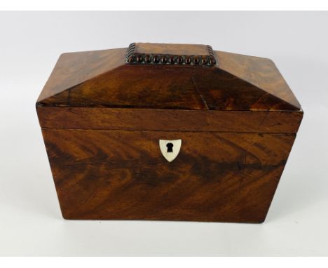 A 19th century flame mahogany sarcophagus form tea caddy, with original lids and brass knobs to the interior, 20.5cms wide x 