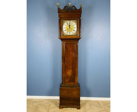 A late 18th century mahogany 8-day longcase clock, with a swan neck pediment and brass eagle finials, the movement with a bra