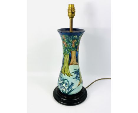 A large Moorcroft table lamp mounted on a circular stand, 43cms overall height x 18cms stand diameter. Estimate £50-80.