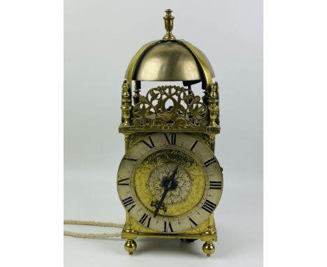 A large brass single hand lantern clock with a silvered chapter ring and striking on a bell, the dial signed Thomas Milles, L