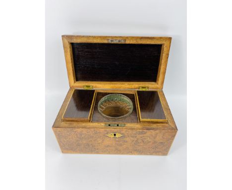 A 19th century burr oak rectangular tea caddy with black and white line inlaid decoration, opening to reveal two lidded tea c
