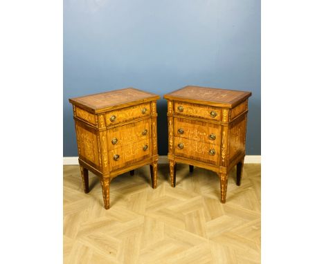 A pair of antique style Italian walnut marquetry inlaid three drawer bedside chests, with brass ring handles and raised upon 