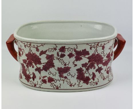 A large antique style ceramic red and white twin handled footbath, 40cms wide x 26cms deep x 18cms high. Estimate £20-40.