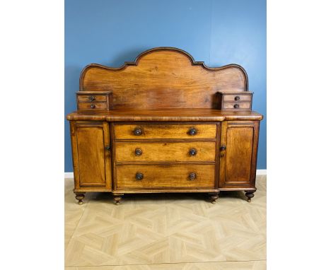 A Victorian mahogany breakfront dresser base, with a bank of three central graduated drawers with original mother of pearl in