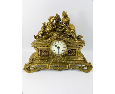 A 20th century French antique style Imperial cast brass mantle clock with a Roman numeral dial, the case with elaborate decor