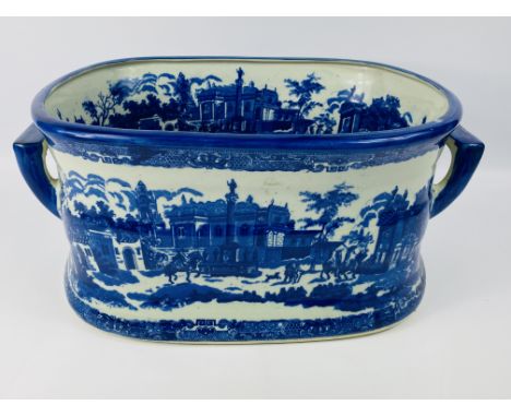 A large antique style ceramic blue and white twin handled footbath, marked to the underside, 45cms wide x 30.5cms deep x 21.5