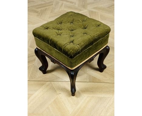 A Victorian mahogany square stool with button back upholstery, carved decoration to all sides and raised upon carved cabriole